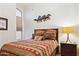 Comfortable bedroom with Southwestern decor and a large window for natural light at 42076 W Colby Dr, Maricopa, AZ 85138