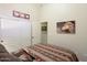 Comfortable bedroom featuring neutral colors, a queen size bed, and closet space at 42076 W Colby Dr, Maricopa, AZ 85138