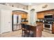 Well-equipped kitchen with stainless steel appliances, granite countertops and a central island at 42076 W Colby Dr, Maricopa, AZ 85138