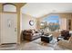 Inviting living room with large windows, vaulted ceiling, and comfortable seating at 42076 W Colby Dr, Maricopa, AZ 85138