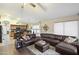 Spacious living area with comfortable leather seating, modern décor, and kitchen views at 42076 W Colby Dr, Maricopa, AZ 85138