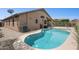 Backyard pool with desert landscaping, and a covered patio enhance outdoor enjoyment at 42076 W Colby Dr, Maricopa, AZ 85138