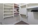Walk-in closet with ample storage space, shelving, and hanging racks at 42076 W Colby Dr, Maricopa, AZ 85138