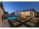 Serene backyard featuring a pool, patio, and well-manicured artificial turf at 4346 S Synapse Dr, Mesa, AZ 85212