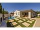 Beautiful backyard with a pool, patio, and unique stone/turf design, perfect for entertaining and relaxation at 4346 S Synapse Dr, Mesa, AZ 85212