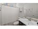 Well-lit bathroom with a shower/tub, white towels, and a vanity with a gray tile backsplash at 4346 S Synapse Dr, Mesa, AZ 85212