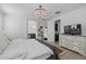 Bright bedroom featuring a chandelier, ensuite bathroom, and light wood floors at 4346 S Synapse Dr, Mesa, AZ 85212