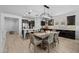 Light and bright dining area features modern pendant lights, dark cabinets, and access to the kitchen area at 4346 S Synapse Dr, Mesa, AZ 85212