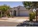 Beautiful one-story home features a two-car garage and lush landscaping in the front yard at 4346 S Synapse Dr, Mesa, AZ 85212