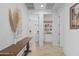Hallway with light wood floors, a rustic wood table, and doorways to other rooms at 4346 S Synapse Dr, Mesa, AZ 85212