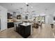 Open-concept kitchen showcases a large island, stainless steel appliances, and seamless flow to dining and living areas at 4346 S Synapse Dr, Mesa, AZ 85212