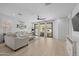 Bright living room boasts wood-look tile flooring, stylish furnishings, and sliding glass doors to the patio at 4346 S Synapse Dr, Mesa, AZ 85212