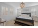 Bright main bedroom with a decorative chandelier, plantation shutters, a neutral color palette, and wood-look flooring at 4346 S Synapse Dr, Mesa, AZ 85212