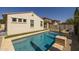 A view of the sparkling pool in the backyard, with stone accents and meticulous landscaping; great for a swim at 4346 S Synapse Dr, Mesa, AZ 85212