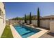 Backyard swimming pool with stone accents and carefully manicured landscaping that is great for entertainment at 4346 S Synapse Dr, Mesa, AZ 85212