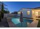 Backyard swimming pool with a striped patio umbrella and stone accents, perfect for hot summer days at 4346 S Synapse Dr, Mesa, AZ 85212