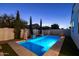 Private pool area featuring a pool with an umbrella and verdant landscaping; perfect for hot days at 4346 S Synapse Dr, Mesa, AZ 85212