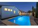 Inviting backyard pool with cool blue water and carefully manicured landscaping; great for evening relaxation at 4346 S Synapse Dr, Mesa, AZ 85212