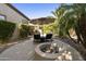 Charming backyard oasis with a fire pit, lounge chairs and lush landscaping at 4524 E Narrowleaf Dr, Gilbert, AZ 85298