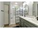 Modern bathroom boasts double sinks, quartz countertop, and a glass-enclosed shower with subway tile and black accents at 4524 E Narrowleaf Dr, Gilbert, AZ 85298
