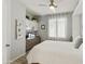 Comfortable bedroom with a ceiling fan and built-in shelving and desk space at 4524 E Narrowleaf Dr, Gilbert, AZ 85298