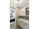 Butler's pantry boasts decorative backsplash, built-in cabinets and shelving, and a view into the bedroom at 4524 E Narrowleaf Dr, Gilbert, AZ 85298