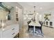 Elegant dining area with a chandelier, table with seating, and a view into the modern kitchen at 4524 E Narrowleaf Dr, Gilbert, AZ 85298