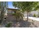 Side view of the home shows charming curb appeal with desert landscaping and a well-manicured yard at 4524 E Narrowleaf Dr, Gilbert, AZ 85298