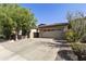 Charming single-story home with a well-manicured front yard, desert landscaping, and a three-car garage at 4524 E Narrowleaf Dr, Gilbert, AZ 85298