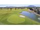 Scenic golf course view features lush green fairways, a serene pond, and the McDowell Mountains in the background at 4524 E Narrowleaf Dr, Gilbert, AZ 85298