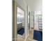 Hallway view of a bathroom with a glass shower, a gray vanity with a marble countertop, and wood-look floors at 4524 E Narrowleaf Dr, Gilbert, AZ 85298