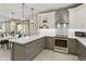 Bright kitchen featuring a center island, gray bottom cabinets, and stainless steel appliances at 4524 E Narrowleaf Dr, Gilbert, AZ 85298