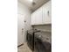 Functional laundry room with modern washer and dryer units, and overhead storage at 4524 E Narrowleaf Dr, Gilbert, AZ 85298