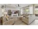 Cozy living room with comfortable seating, a ceiling fan, and large windows providing natural light at 4524 E Narrowleaf Dr, Gilbert, AZ 85298