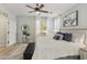Bright, serene bedroom featuring luxury decor, a ceiling fan, and large windows with plenty of natural light at 4524 E Narrowleaf Dr, Gilbert, AZ 85298