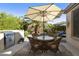 Inviting patio area featuring a wicker table set, grill, and lovely landscaping at 4524 E Narrowleaf Dr, Gilbert, AZ 85298