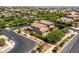 An aerial view of a two-story home with desert landscaping. The image shows the backyard and surrounding neighborhood at 5016 S Curie Way, Mesa, AZ 85212