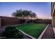 Expansive backyard showcasing manicured lawn, mature landscaping, and a neatly bordered design, perfect for outdoor enjoyment at 5016 S Curie Way, Mesa, AZ 85212