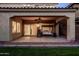 Covered patio with fan, and furniture, overlooks a backyard with lush green grass, perfect for outdoor entertaining at 5016 S Curie Way, Mesa, AZ 85212