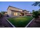 Large backyard featuring green lawn and patio area, ideal for outdoor activities and relaxation at 5016 S Curie Way, Mesa, AZ 85212