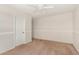 Bedroom boasts neutral walls, carpet flooring and a ceiling fan for comfortable climate control at 5016 S Curie Way, Mesa, AZ 85212