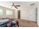 Bedroom with neutral carpeting, a ceiling fan, and an ensuite bathroom at 5016 S Curie Way, Mesa, AZ 85212