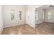 Bright entryway featuring tile flooring, white walls, and natural light from multiple windows at 5016 S Curie Way, Mesa, AZ 85212