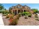 A two-story home featuring a covered porch, tiled roof, well-kept landscaping, and desert flora at 5016 S Curie Way, Mesa, AZ 85212