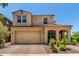 Charming two-story home with a two-car garage, covered entry, and desert landscaping in the front yard at 5016 S Curie Way, Mesa, AZ 85212