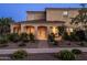 Exterior evening shot of a cozy two-story home with a welcoming entrance and thoughtfully designed front yard landscaping at 5016 S Curie Way, Mesa, AZ 85212