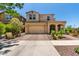 Charming two-story home featuring a two-car garage, covered entry, and desert landscaping in the front yard at 5016 S Curie Way, Mesa, AZ 85212