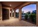 Charming covered front porch with paved flooring, decorative pillars, a secure front door and desert landscaping at 5016 S Curie Way, Mesa, AZ 85212