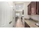 Galley kitchen features granite countertops, dark wood cabinets, and tile flooring at 5016 S Curie Way, Mesa, AZ 85212