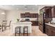 Well-equipped kitchen with dark cabinetry, granite countertops, stainless steel appliances, and a central island at 5016 S Curie Way, Mesa, AZ 85212